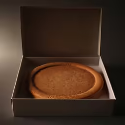 the inside of an opened white box that has a baked cake inside of it