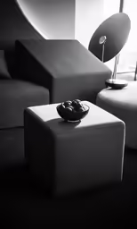 a living room with couch, table and lamp