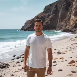 a man stands on the beach and stares away from the camera