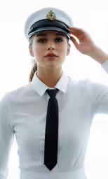 the woman wearing a naval uniform is saluting