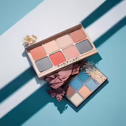 a colorfully colored cosmetics on top of a blue background