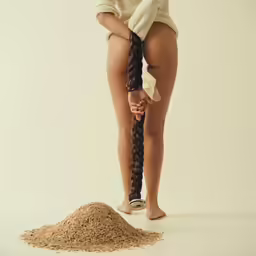 the girl is in a photo shoot holding a large braid