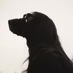 a woman is wearing her reflection as she stares up into the sky
