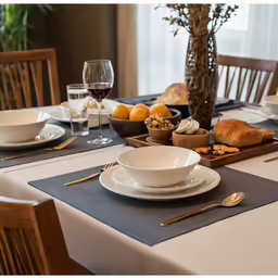 a table topped with plates and bowls filled with food