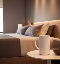 the mug on the table is next to the coffee cup