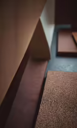 a line of wood and black carpet sits in the middle of a room