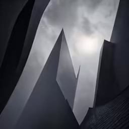 three buildings are standing against the sky