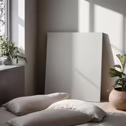a bed is topped with white sheets and pillows