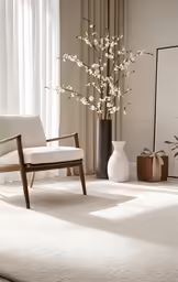 this is a living room with white furniture and flowers
