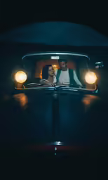 the bride and groom take a backseat together in the car