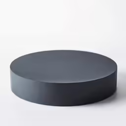 a small round gray object sits on a table