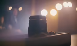 a person sits in the dark next to a camera