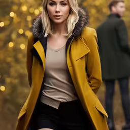 a blonde woman in a brown coat and shorts