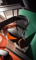 an office chair and stool in a corner