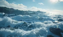 an ocean with lots of waves on it and a bunch of rocks