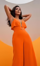 a woman is wearing an orange dress