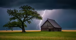 lightning striking over a barn on a stormy day