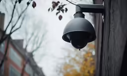 a security camera hanging from the side of a building