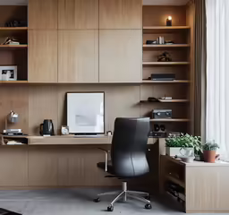 an office with wooden shelves and a leather chair