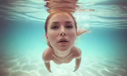 an underwater photo of a woman under water