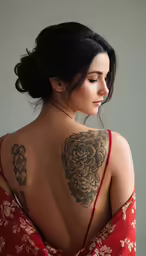 a beautiful young woman with a tattoo on her back