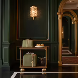 a hotel room filled with luggage and gold accents