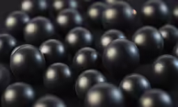 a photo of a bunch of balls that look like they are black