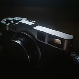 a camera with its flash light on on a dark background