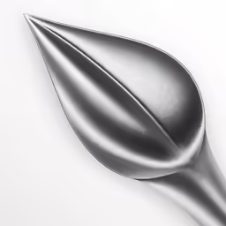 the tip of a silver colored spoon on a white surface