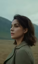 a girl is posing for the camera in a field