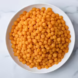 several rows of tiny yellow foodstuffs in a white bowl