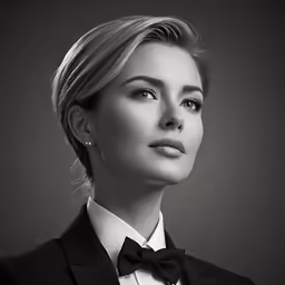the woman with blonde hair and wearing a tuxedo