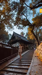 woman walking down rail road track with train station in the background