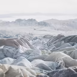 the person is laying down with a white blanket