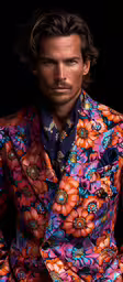 a man dressed in a brightly colored suit with flowers on it,a man with a colorful shirt and floral print jacket