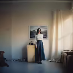 a woman stands beside the door in her living room