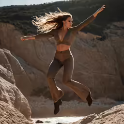 woman in leopard print pants leaping off large rock