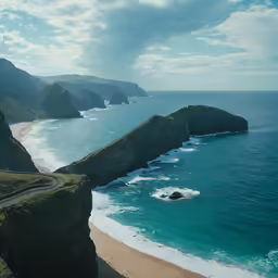 the ocean and rocks along side a beach
