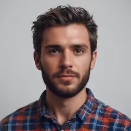 a man with a beard and blue checkered shirt