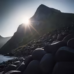 there is sun shining over rocks and water