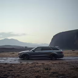 a silver car parked on the side of a dirt road