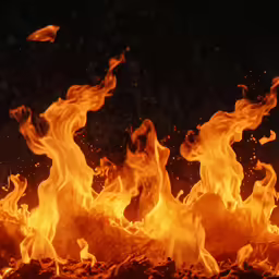 a bunch of yellow fire burning in the dark
