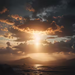 the sun shining through the clouds over the ocean