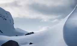 a man skiing down the side of a snow covered mountain