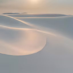 sand dunes with a sunset in the background