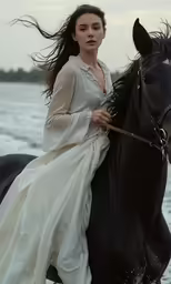 the woman in the white dress is riding on a horse
