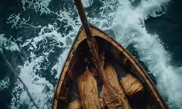 the man on the boat is very close to the water