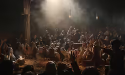 a crowd in a crowded building on a dimly lit stage