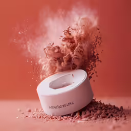 powder spilling out of an ashtray container onto rocks