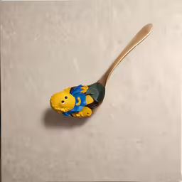 a spoon that has a ceramic fish on it